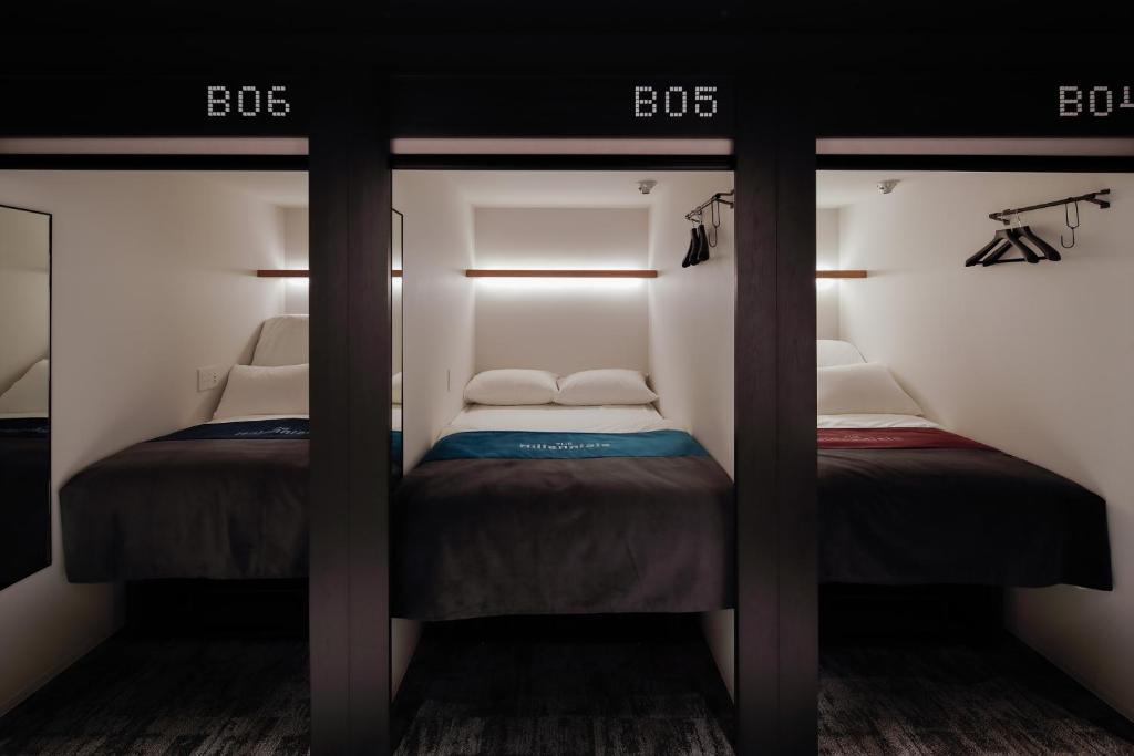 Stacked sleeping pods on a floor shared with desks in central Kyoto.