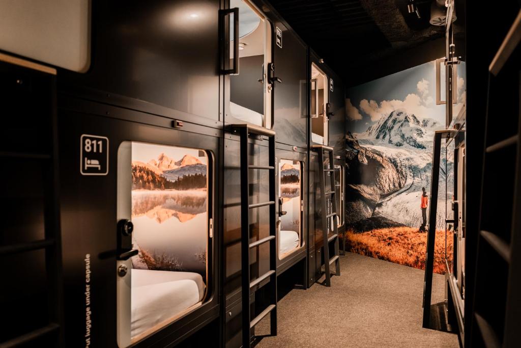A row of fitted sleeping units along a shared passage.